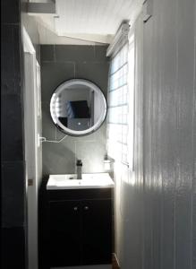 a bathroom with a sink and a mirror at Hostal Abrazo de Maipu in Santiago
