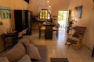 a living room and kitchen with a couch and a table at Casa Chukum en Rio Lagartos in Río Lagartos