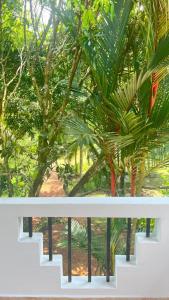 a view from a balcony of a palm tree at Larala Villa with private pool in Mawadawila