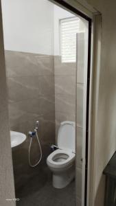 a bathroom with a toilet and a sink at River way in Ratnapura