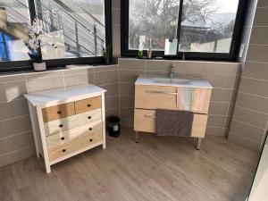 a bathroom with a sink and a dresser and a window at Chambre pour 4 personnes avec SdB privative et jacuzzi in Le Petit-Couronne +13 photos