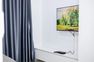 a flat screen tv hanging on a wall in a room at The Parresia Haven in Harare