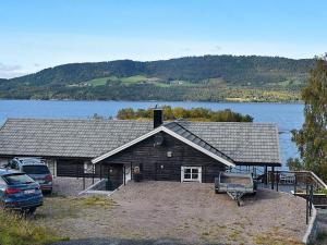 a log cabin with a view of a lake at 8 person holiday home in TORVIKBUKT in Torvikbukt