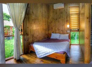 a bedroom with a bed in a wooden room at DuGiang Homestay in Buon Ma Thuot