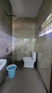 a bathroom with a toilet and a sink at Private room in a residential area in Hospet