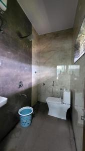 a bathroom with a toilet and a sink at Private room in a residential area in Hospet