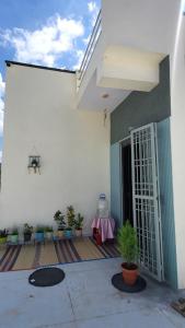 an open door to a building with potted plants at Private room in a residential area in Hospet +10 photos