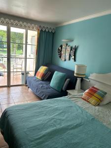 a living room with a bed and a couch at la Désirade in Sainte-Luce