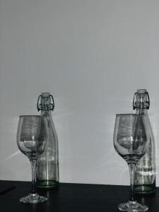 two empty wine glasses sitting on top of a table at Hiriketiya Green Haven Villa in Dickwella