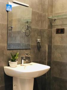 a bathroom with a white sink and a mirror at Hiriketiya Green Haven Villa in Dickwella