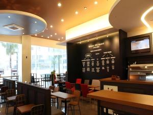 a restaurant with tables and chairs and a sign on the wall at Hotel Sunshine in Daejeon +57 photos