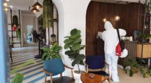 a person in a room with chairs and a person in a store at Fun Hotel in Rayong