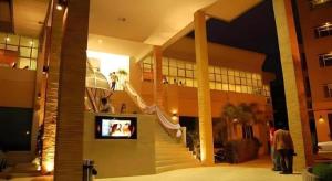a building with a staircase and a tv in it at Western Grand Hotel Ratchaburi in Ratchaburi