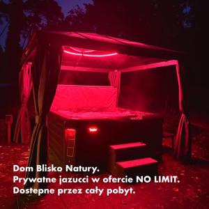 a red tent with a stool in it at Dom Blisko Natury Brenno in Brenno