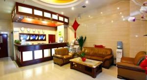 a lobby with couches and a bar in a store at GreenTree Inn Xi'an Bell and Drum Tower Food Street Ancient City Wall Ximen Express Hotel in Xi'an