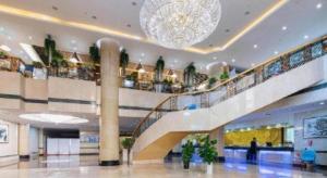 a large lobby with a staircase in a building at Qingdao Haidu Hotel in Huangdao +181 photos