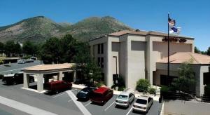 a parking lot with cars parked in front of a building at Flagstaff Hotel in Flagstaff