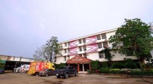 a building with a truck parked in front of it at PC Palace Hotel in Sakon Nakhon