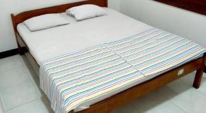 a bed with two pillows on top of it at Hotel Wijaya Magelang in Magelang +27 photos