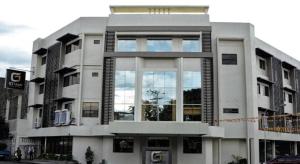 a building with a lot of windows on a street at GT Hotel Bacolod in Bacolod