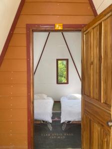 a small room with two beds in a house at Mountain View dormitory in Ban Sôphoun +17 photos