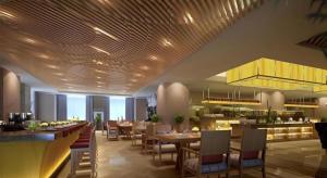a dining room with tables and chairs in a restaurant at Zhejiang D.H Hotel in Haining