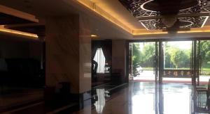 a lobby with a large glass door to a pool at Nanning Qian Xi International Hotel in Nanning