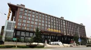 a large brown building with a lot of windows at Wuhan Gaotie Kairui International Hotel in Wuhan
