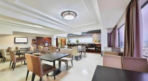 a dining room with tables and chairs in a restaurant at Telecom Hotel Guilin in Guilin