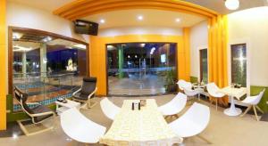a lobby with a table and chairs and a pool at Chodkamol Place 57 in Nakhon Si Thammarat