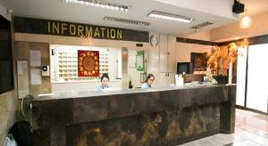 two women sitting at a counter in a restaurant at Numsin Hotel in Ratchaburi