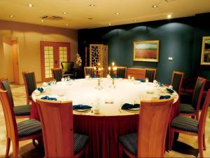 a large table with chairs around it in a room at Huangshan Scholars Conference Hotel in Huangshan