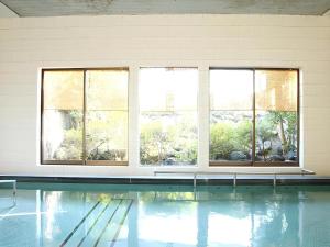 a swimming pool with windows in a building at Daitoku Hotel in Choshi