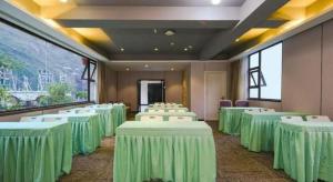 a room with green and white tables and chairs at Xana Lite Ganzi Luding YanAn Road in Garze