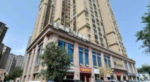 a tall building with a large building at Xana Lite Korla Shihua Avenue Longquehe in Korla