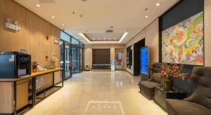 a lobby of a hospital with a large painting on the wall at Yitel Shenyang Sanhao Street Shengjing Hospital in Shenyang
