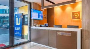 a mcdonalds restaurant with a bar in a building at IU Hotel Kunming Jinma Bijifang Joy City in Kunming