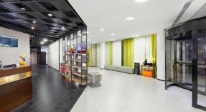 a large room with a store with colorful curtains at Jinjiang Inn Select Tianjin Xiaobailou Metro Station in Tianjin