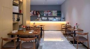 a row of tables and chairs in a restaurant at danfeng kelly hotel in Dapeng