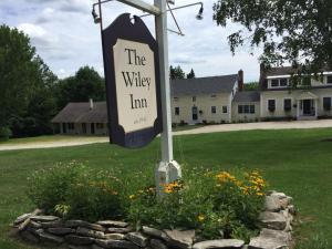 a sign for the valley inn in a field of flowers at Wiley Inn in Peru