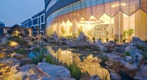 a building with a pond in front of a building at YONG JING VILLA in Suzhou