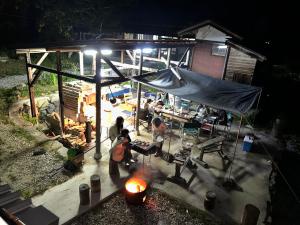 a group of people sitting in a tent at night at ANBAEE Private Mountain Villa あんばええ in Nakatsugawa