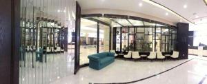a store with a blue chair in a room at Xana Hotelle·Tianshui Shangyi Plaza in Tianshui