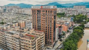 an aerial view of a city with buildings at Borrman Hotel Puning International Commodity City Wantaihui in Jieyang