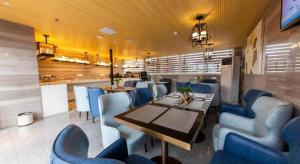 a dining room with blue chairs and a table at Echarm Hotel Fuzhou Sanfang Qixiang East Street Metro Station in Fuzhou
