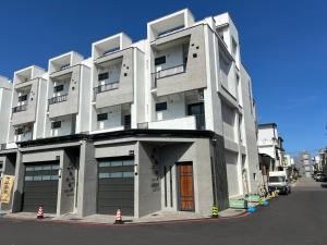 Un gran edificio blanco al costado de una calle. en Tiansheng Anjia B&B, en Taitung
