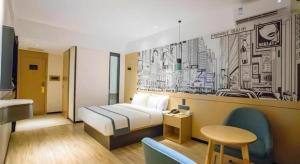 a hotel room with a bed and a table and chairs at City Comfort Inn Beiliu Yongfeng Plaza Chengnan Bus Station in Yulin +217 photos