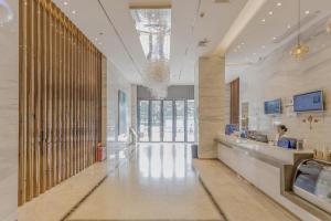 a lobby of a building with a reception counter at City Comfort Inn Foshan Gaoming Huaying Square in Foshan