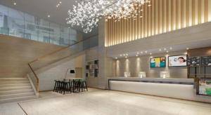 a lobby with a staircase and a table in a building at City Comfort Inn Dongguan Zhongtang in Guangzhou