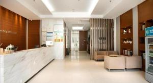 a lobby of a store with a counter and chairs at City Comfort Inn Yichang Dongshan Three Gorges University Shuiyuecheng in Yichang